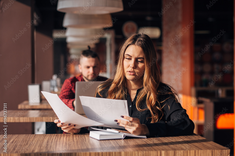 pensive businesswoman looking documents in a cafe pensive businesswoman looking documents in a cafe