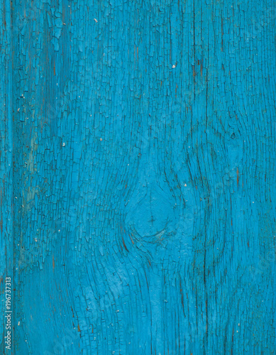 Blue wooden background. Painted wood board surface with cracks. Bright abstract background with place for text. Closeup view.
