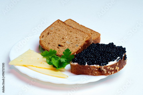 caviar sandwich on a white plate with cheese