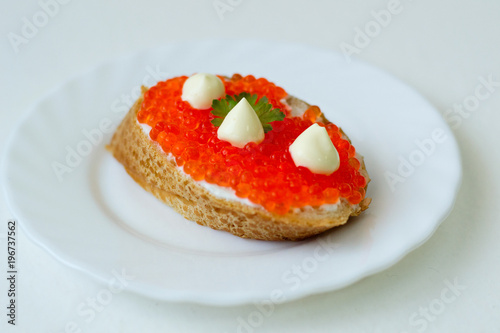 caviar sandwich on a white plate