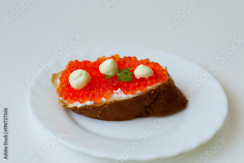 caviar sandwich on a white plate