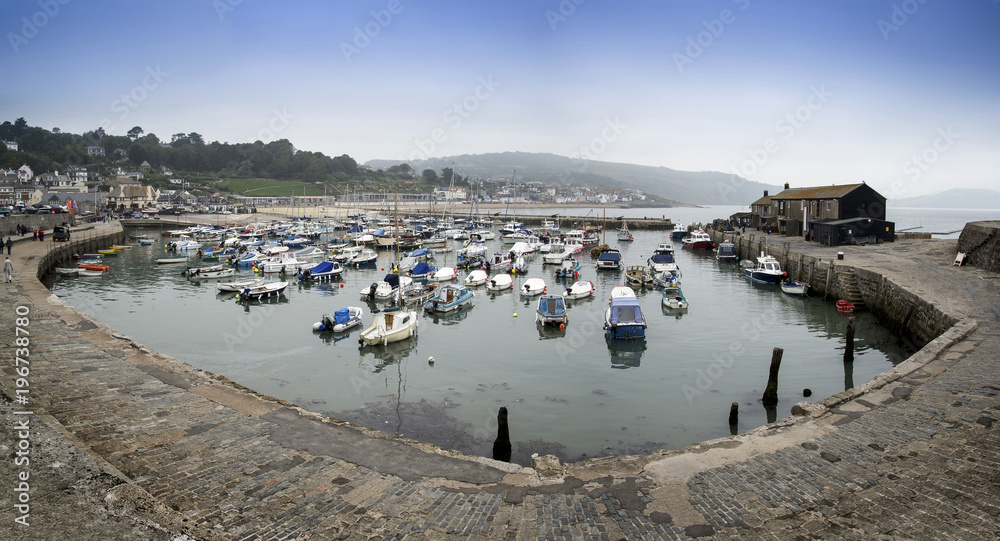 Stunning panorama landscape of traditional fishing harbour at Lyme Regis in England