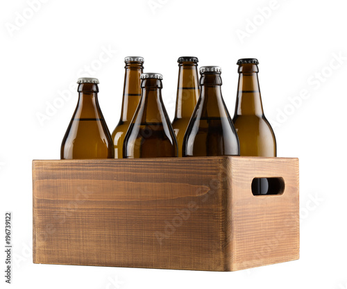 Craft beer bottles in wooden box isolated on white background