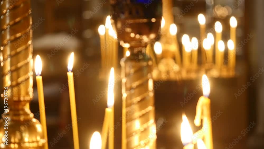 Candles flaming in candlestick in church Candles flaming in candlestick in church