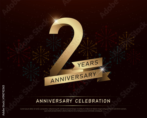 2nd years anniversary celebration gold number and golden ribbons with fireworks on dark background. vector illustration