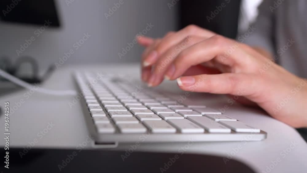 Woman office worker typing on the keyboard Woman office worker typing on the keyboard