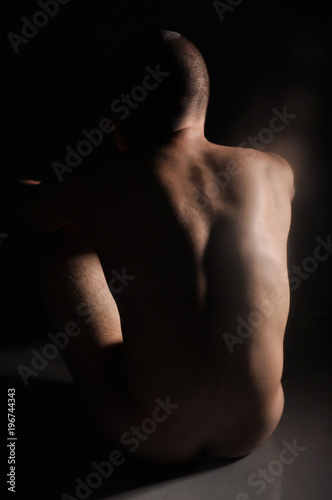 naked man on black background