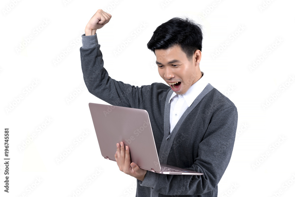 Young Asian male student in grey jacket holding laptop and raising his fist expressing successful in something isolated on white background Young Asian male student in grey jacket holding laptop and raising his fist expressing successful in something isolated on white background