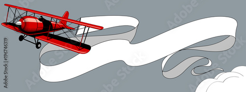 Retro red airplane with a big white ribbon banner in the sky