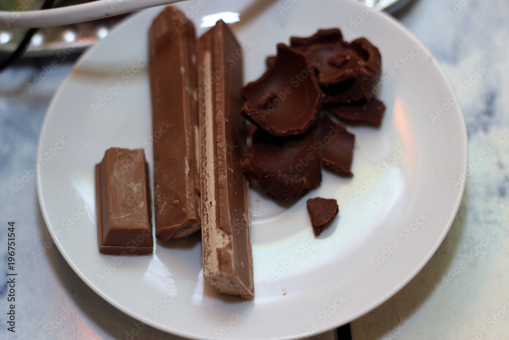 dark chocolate and milk chocolate on a white plate dark chocolate and milk chocolate on a white plate