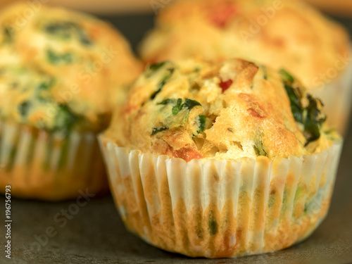 Freshly baked savoury muffins with cheddar, spinach and bell pepper