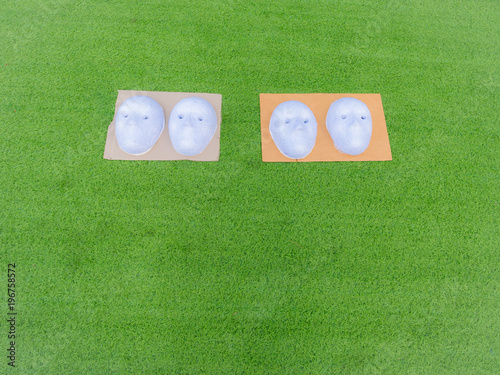 White Paper Mache Masks in The Lawn photo
