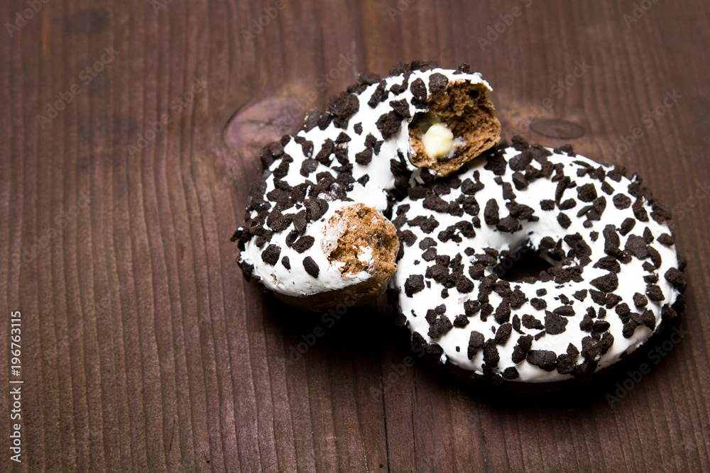 Traditional donuts on wooden background. Tasty doughnuts with icing, copy space Traditional donuts on wooden background. Tasty doughnuts with icing, copy space