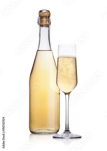 Bottle and glass of yellow champagne with bubbles