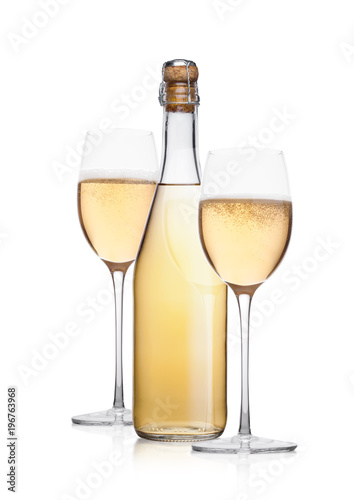 Bottle and glass of yellow champagne with bubbles