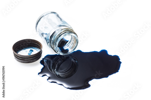 Photography Deep blue colour ink spill from old glass inkwell with the rusty cap on white ba