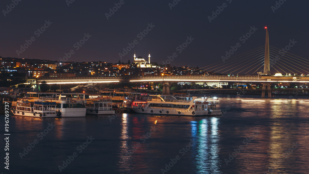 Night view of Unkapani Ataturk subway bridge on the Golden Horn in Istanbul, Turkey.