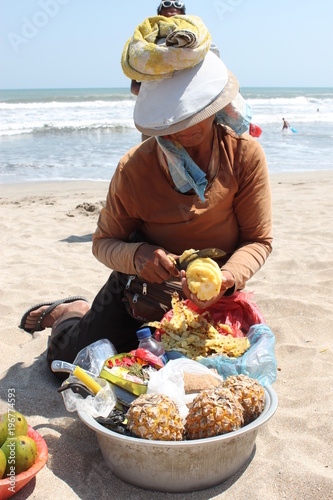 Woman selling fresh fruits at the beach, Bali