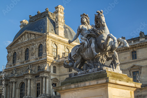 Stone statue of Louvre Palace in Paris