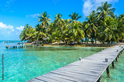 Tobacco Caye - Relaxing on Wooden Pier on small tropical island at Barrier Reef with paradise beach, Caribbean Sea, Belize, Central America © Simon Dannhauer