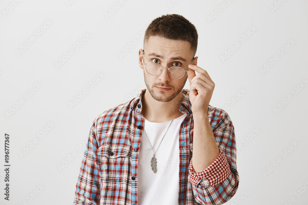 You really mean what you said. Surprised or questioned attractive student taking off trendy glasses and looking at camera as if being stunned with sudden question or revelation over gray wall You really mean what you said. Surprised or questioned attractive student taking off trendy glasses and looking at camera as if being stunned with sudden question or revelation over gray wall
