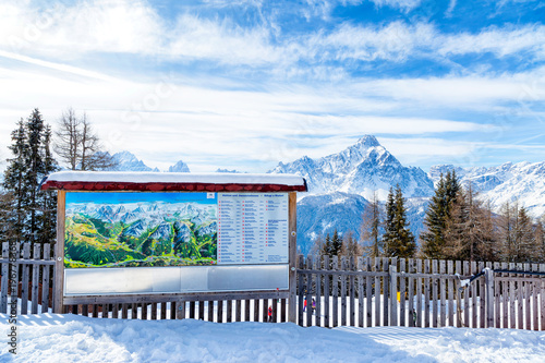 Information sign and map of the Dolomiti with Trentino Alto Adige's peaks in the background, San Candido. Italy