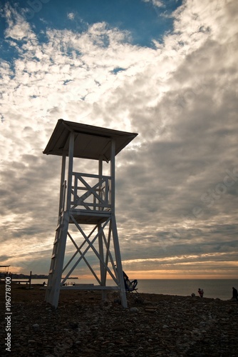 Lifeguard tower on the beach on the beauty sky background.