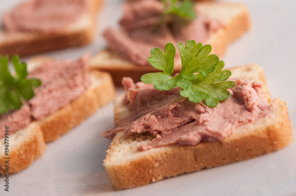 closeup of little toasts with pork and parsley