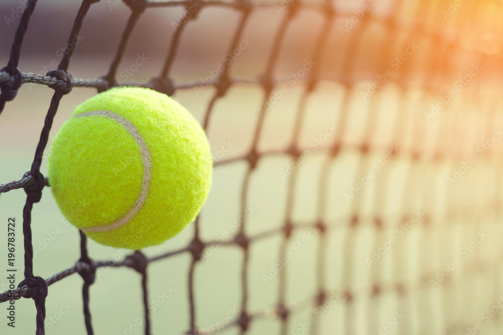 Close up tennis ball hitting to net on blur background	