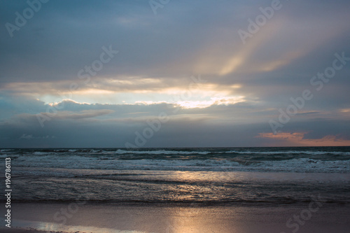 sunrise on the beach among the clouds © Igor