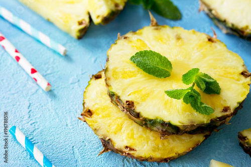 Fresh slice pineapple on stone background or slate with copy space. Food concept.