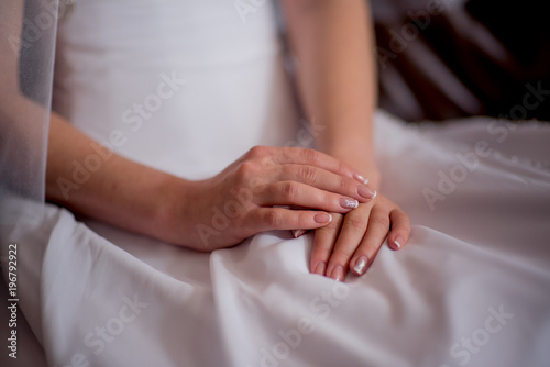bride's hands are on his knees