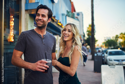 attractive romantic couple spending time together on sidewalk in los angeles