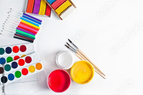 paints for drawing and tools, materials for creativity. White background, top view.