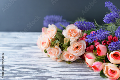 a bouquet with pink roses flowers on a light rural background in spring and summer on Mother's Day, a holiday on March 8 and Thanksgiving Day