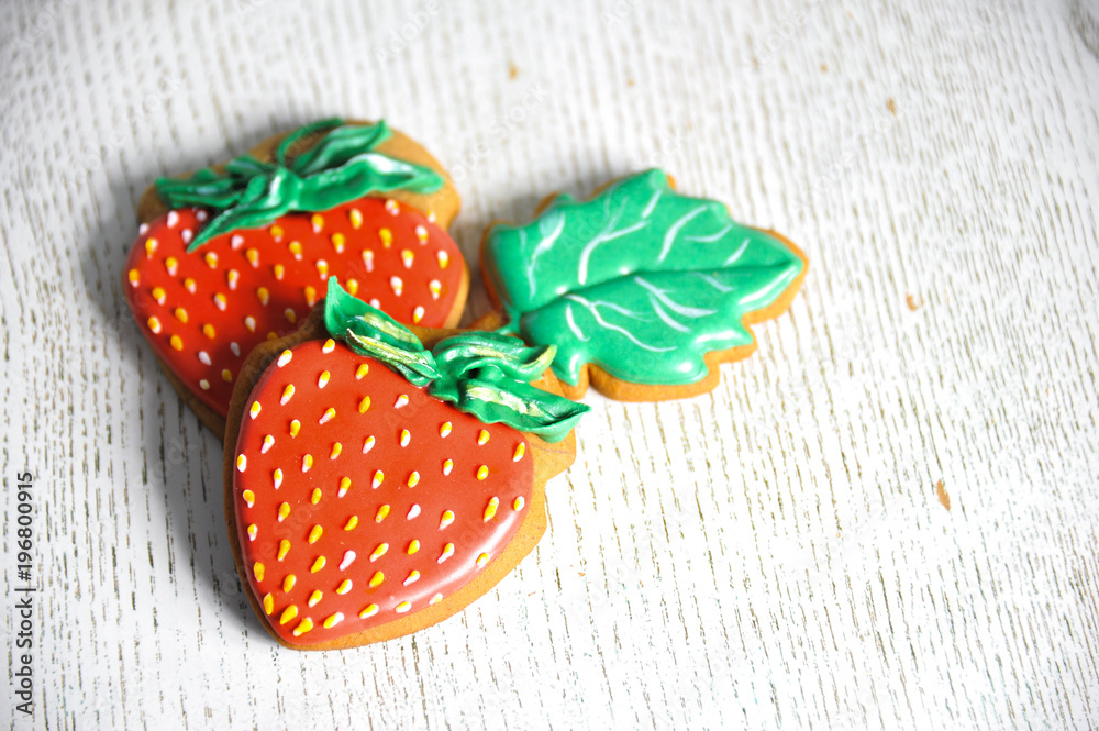 Two gingerbreads in the form of red strawberries. Close-up
Two gingerbreads in the form of red strawberries. Close-up