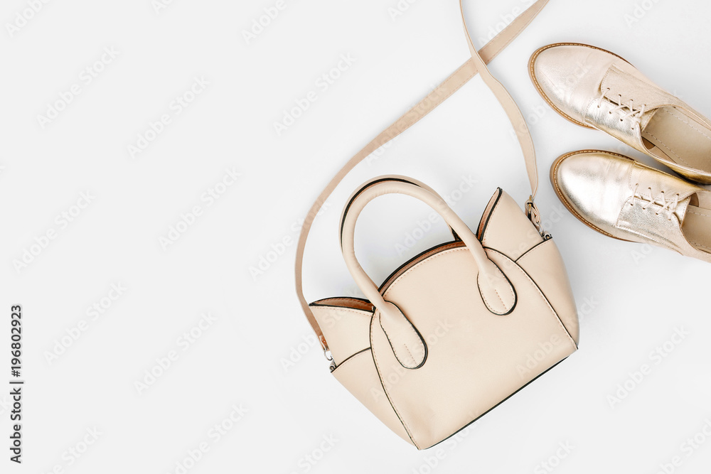 Lovely blue ladies bag and stylish golden shoes. Flat lay, top view. Spring fashion concept Lovely blue ladies bag and stylish golden shoes. Flat lay, top view. Spring fashion concept