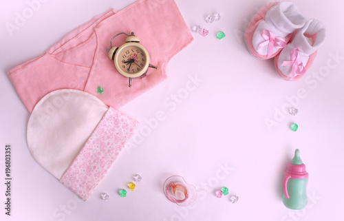 accessories for the baby, hat, baby's undershirt, bootees, pacifier, rhinestones, toy, alarm clock, watch.