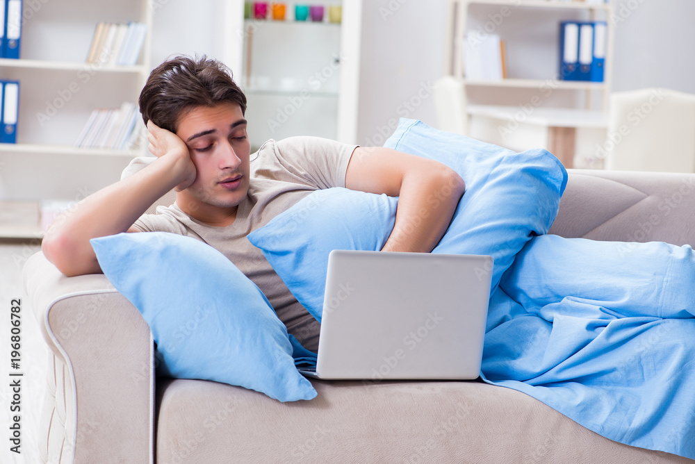 Man working late at his laptop at home Man working late at his laptop at home