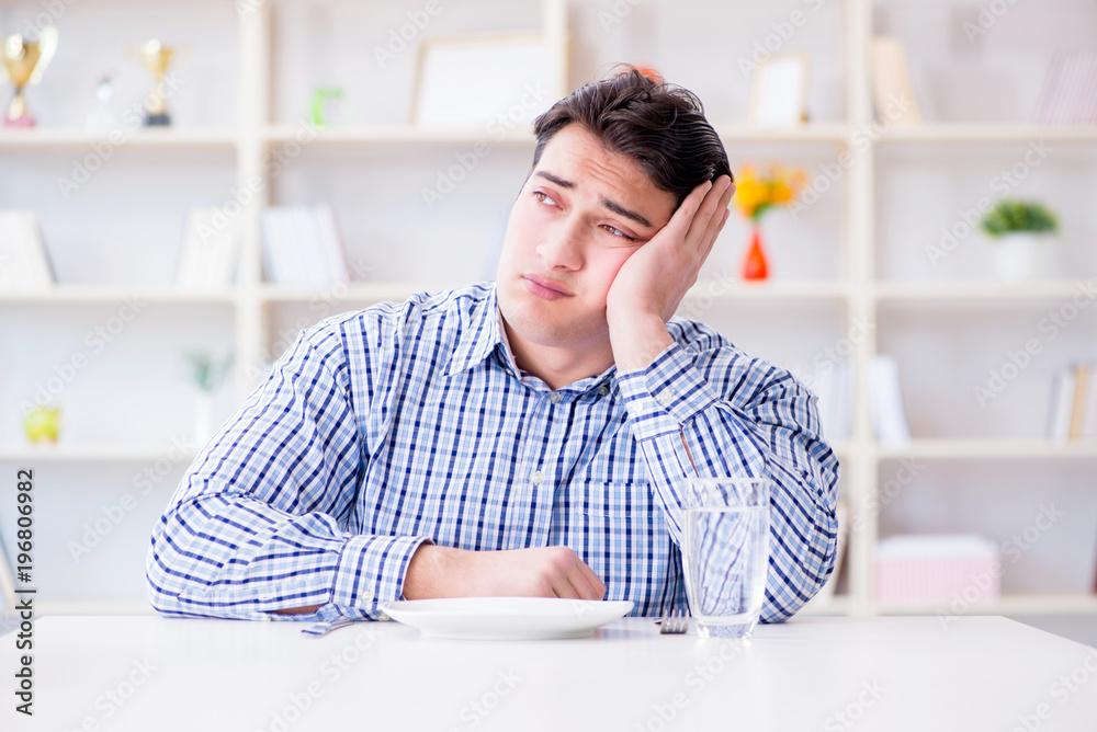 Man on diet waiting for food in restaurant
