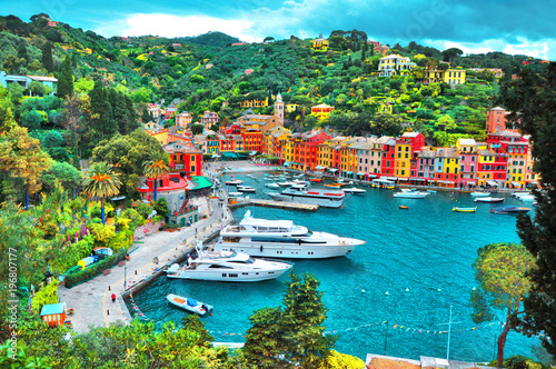 Canvas Print PORTOFINO , ITALY - MAY 02, 2016: The beautiful Portofino with colorful houses and villas, luxury yachts and boats in little bay harbor