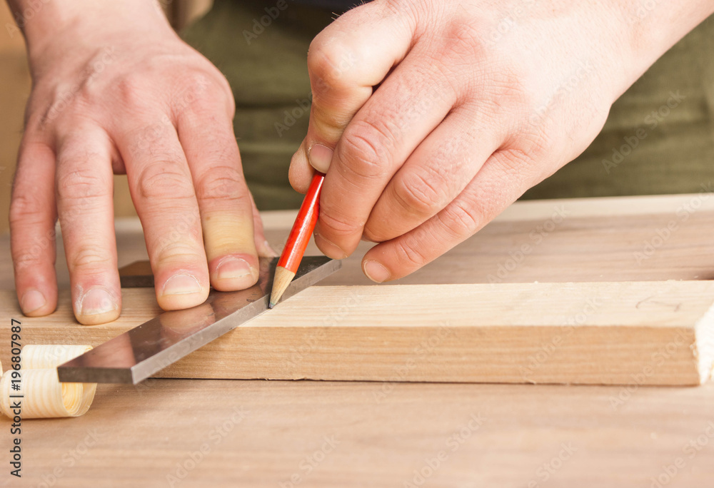 carpenter makes markings in red pencil carpenter makes markings in red pencil