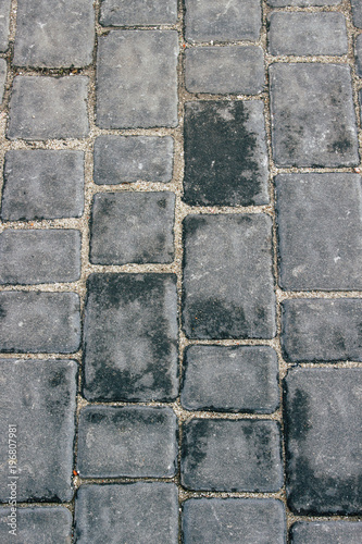 Background. Gray brick road after rain. Pattern.