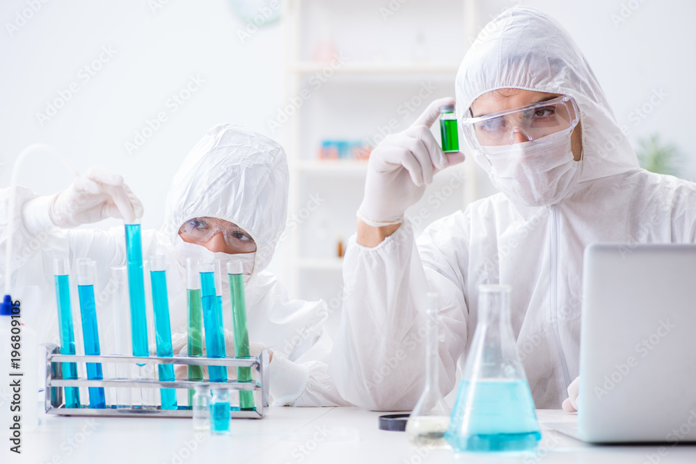Two scientists working in the chemical lab Two scientists working in the chemical lab