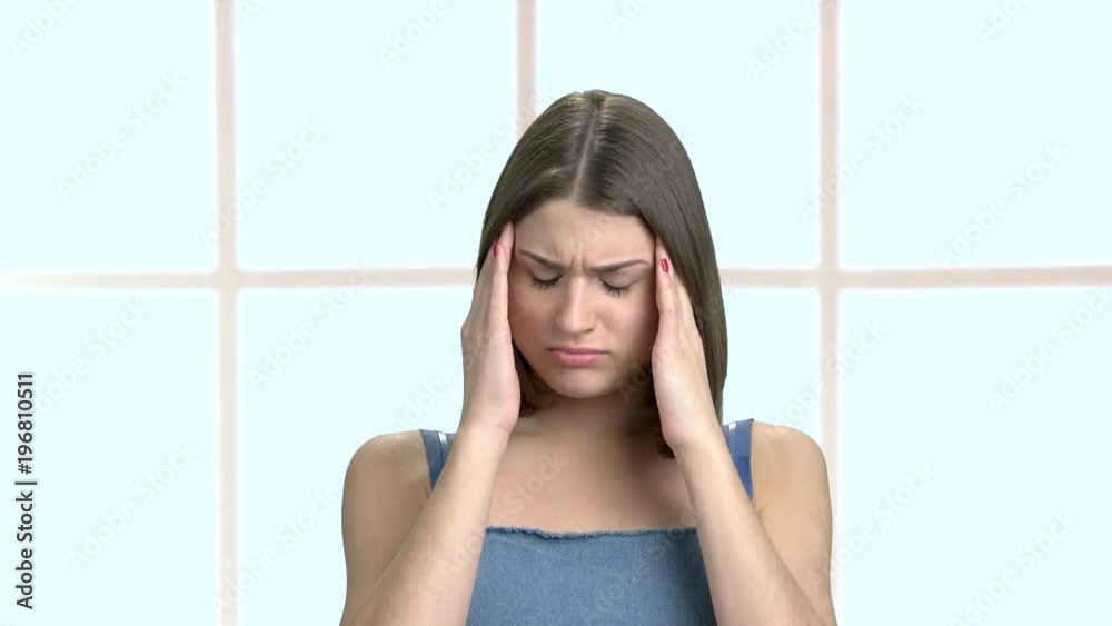Youn woman feeling strong head pain. Portrait of tired stressed young female. Medical problems and healthcare. Youn woman feeling strong head pain. Portrait of tired stressed young female. Medical problems and healthcare.