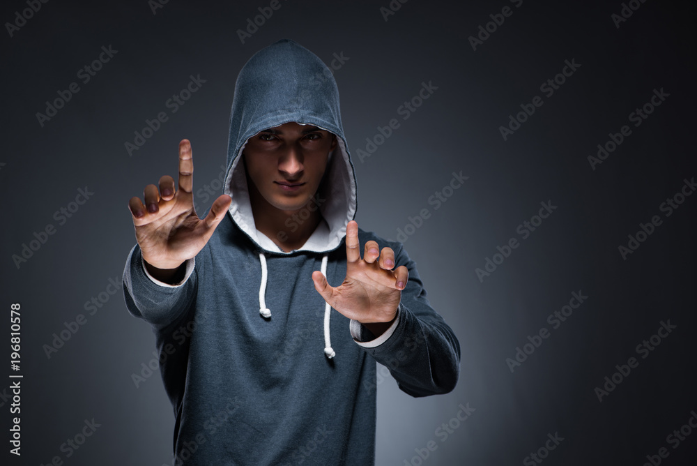 Young man wearing hoodie pressing virtual buttons Young man wearing hoodie pressing virtual buttons