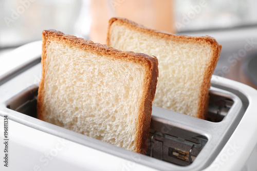 Slices of bread in toaster, closeup