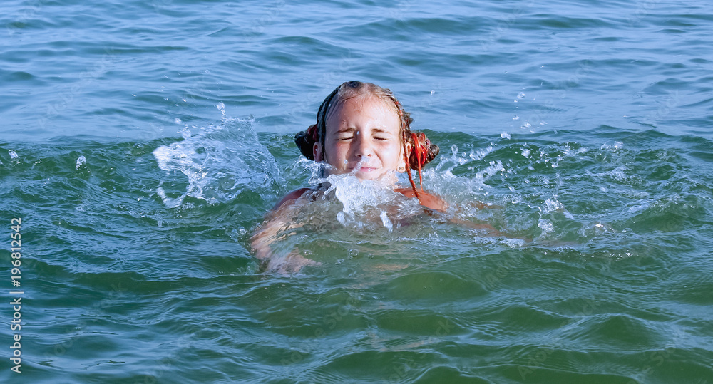 Danger in the water: swim safety rules. Young girl learn to swim  in sea.