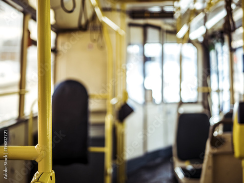 bus interior close blurry yellow railing