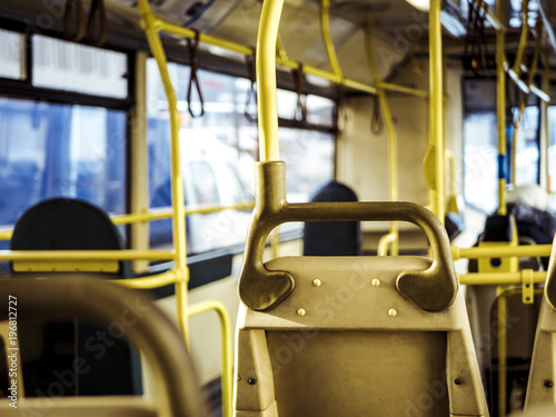 bus interior close blurry yellow railing